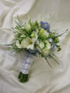 White and blue handtied bouquet with freesia, roses and delphiniums